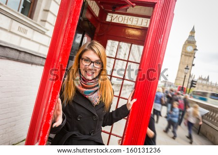 Young Woman Next To London Traditional Telephone Booth