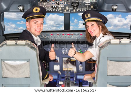 Happy Pilots in the Cockpit with Thumbs Up