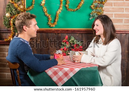 Girlfriend and Boyfriend exchanging Christmas Gifts