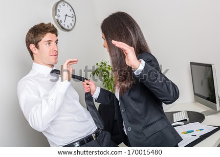Bully Businesswoman Holding Colleague\'s Necktie