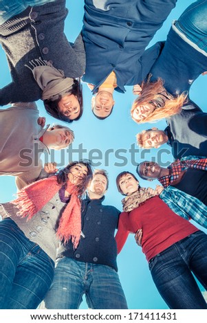 Multiracial People Holding Hands in a Circle, Low Angle View