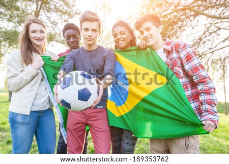 Teenage Friends Holding Brazilian Flag and Soccer Ball