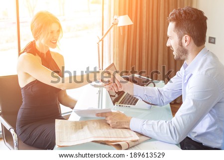 Man and Woman giving Handshake at Office