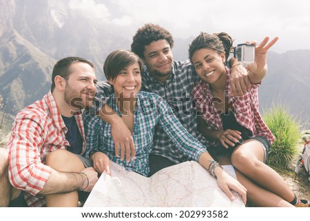 Friends Taking Selfie at Top of Mountain