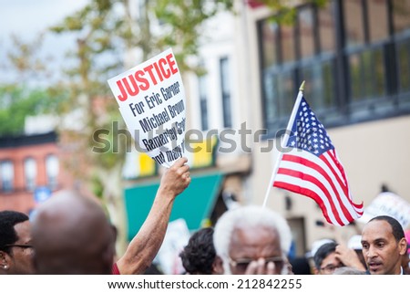 NEW YORK, USA - AUGUST 23, 2014: People asking for justice during march in Staten Island to protest Eric Garner\'s death by NYPD cops.