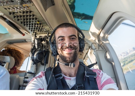 Young Man Taking Selfie in Helicopter Cabin While Flying