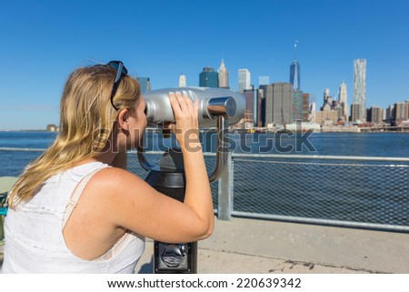 Young Woman Looking through Binoculars in New York