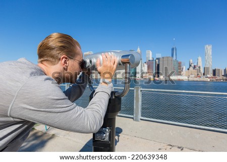Young Man Looking through Binoculars in New York
