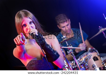 Man and Woman Playing and Singing Rock Music