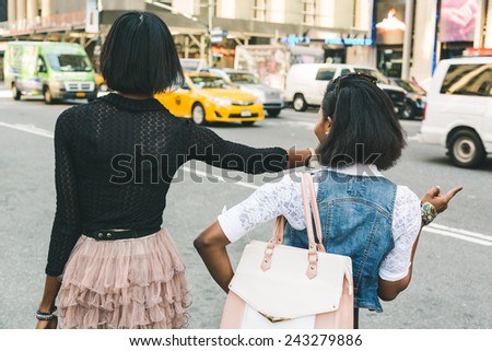 Two Beautiful Black Woman Calling a Taxi in New York