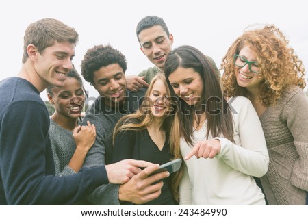 Multiethnic Group of Friends Looking at Mobile Phone