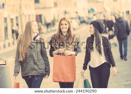 Happy Women Walking in the City with Shopping Bags. They have different Clothing styles but they seem to be in a really good friendship