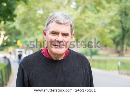 Retired Senior Man at Park, Walking and Relaxing, Smiling Expression