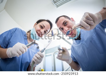 Dentists Holding Dental Tools Looking at Camera with Scary Faces. Personal or Patient Point of View, POV. Dental Fear theme.