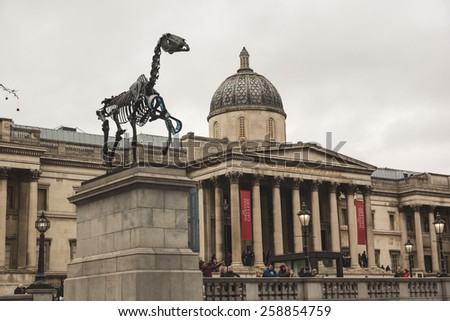 LONDON, UNITED KINGDOM - MARCH 8, 2015: Gift Horse, the new sculpture on the Fourth Plinth in Trafalgar Square, with National Gallery on background