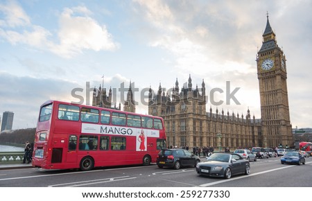 LONDON, UNITED KINGDOM - MARCH 8, 2015: Westminster palace and Big Ben and traffic on Westminster bridge in foreground
