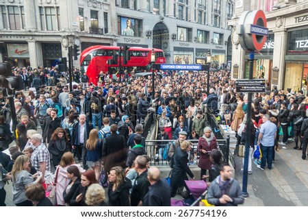 LONDON, UK - APRIL 08, 2015: Crowded Oxford Circus Station entrance due to severe delays in the tube Central Line. Lots of commuters and tourists waiting on the street to enter the station.
