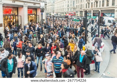 LONDON, UK - APRIL 08, 2015: Crowded Oxford Circus Station entrance due to severe delays in the tube Central Line. Lots of commuters and tourists waiting on the street to enter the station.