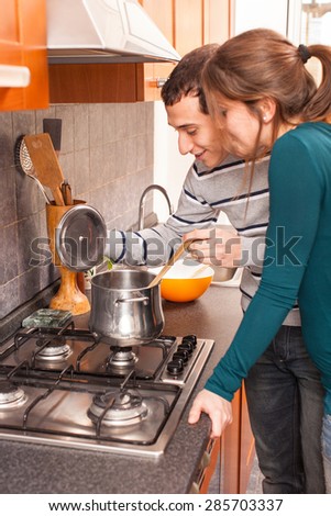 Wife and Husband Cooking Together in the Kitchen