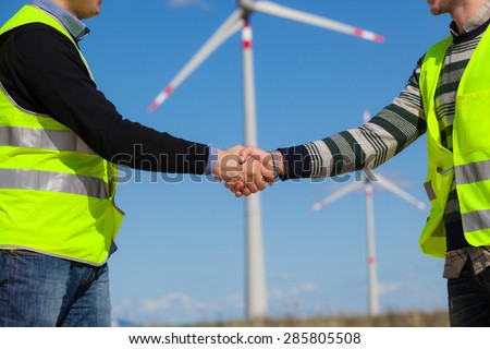 Engineers giving Handshake in a Wind Turbine Power Station
