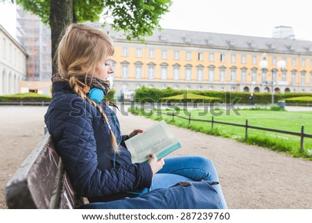 Beautiful German Woman Reading a Book at Park
