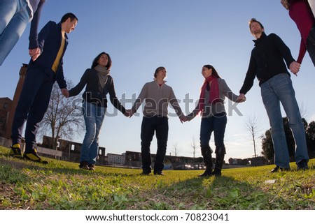 people holding hands in circle. people holding hands in circle. Young People Holding Hands