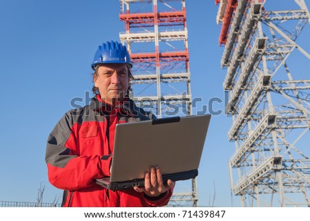 Engineer with Computer in Construction Site
