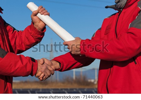 Engineer Handshake with Plans Delivery