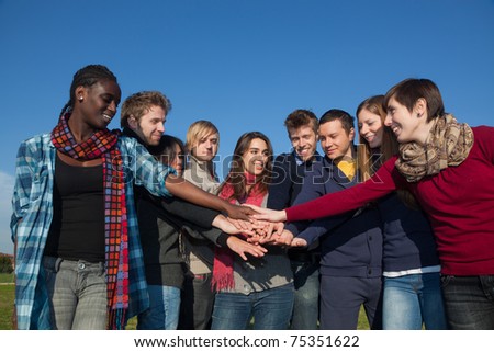 Happy College Students with Hands on Stack