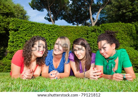 Teenage Female Friends Lying on Green at Park