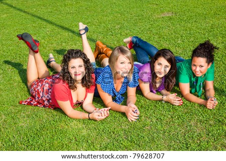 Teenage Female Friends Lying on Green at Park