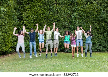Happy Teenage College Students Jumping at Park