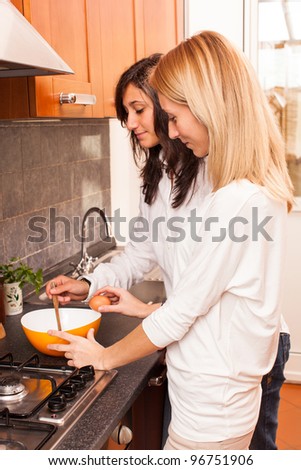 Two Female Friends Cooking in the Kitchen