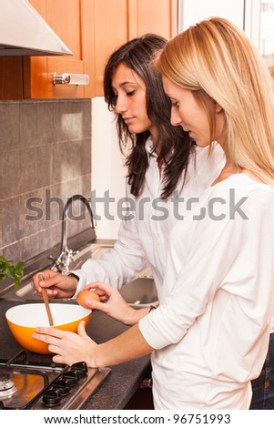 Two Female Friends Cooking in the Kitchen