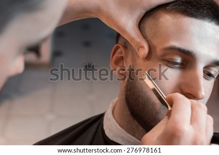 Man having a shave at the barber shop.