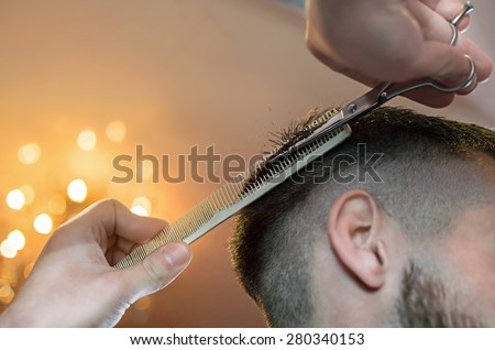 Men\'s hairstyling and haircutting in a barber shop or hair salon.