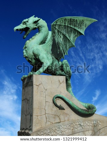 Sculpture of dragon on Dragon bridge on beautiful cloudy sky background in Ljubljana, Slovenia