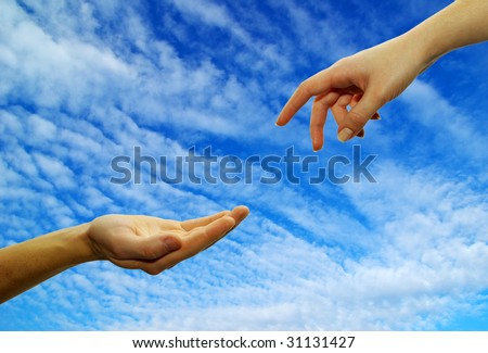 Extended hand for help on a sky background