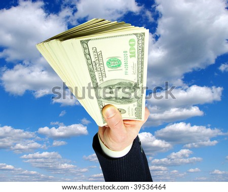 Money in hands on sky