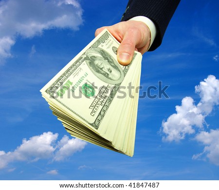 Money in hands on sky