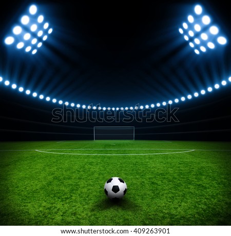 Soccer ball on green stadium, arena in night illuminated bright spotlights