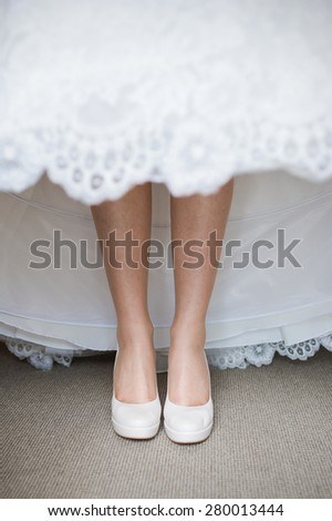 legs of the bride wedding dress covers before ceremony in church