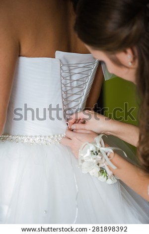 Bride in Wedding Dress. bride-maid clothe white wedding dress for bride
