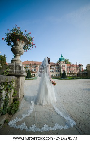 young bride with bouquet before the wedding ceremony, medieval castle