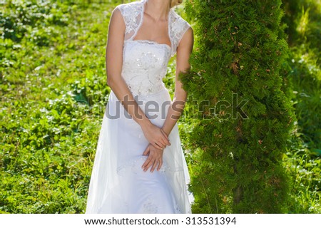Beautiful bride in wedding dress preparing to ceremony in church. Walking near old castle