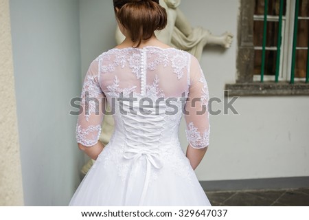 Bride in Wedding Dress before ceremony in church. Bride walking inside castle.
