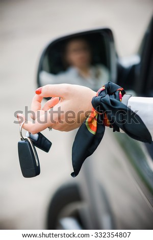 Car Key. Seller woman hand giving key
