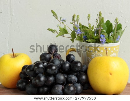 Composition with fruits and white flowers of apple-tree in a cup