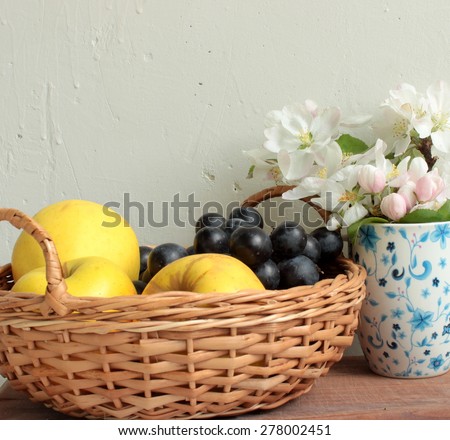 Composition with basket with fruits and flowers of apple-tree