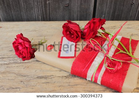 Gift wrapped with paper, cloth and natural rose with message